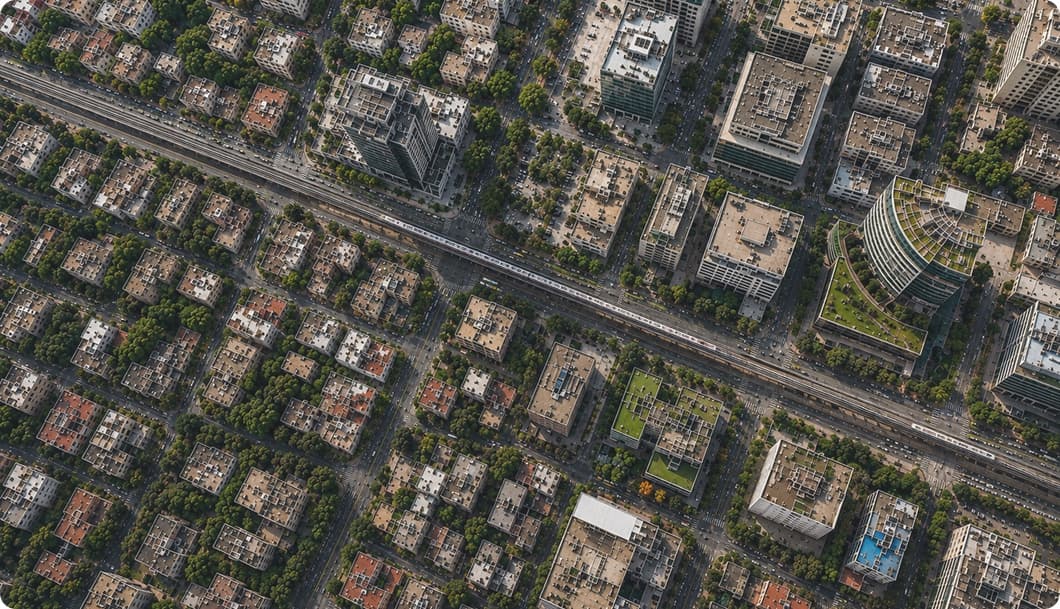 An aerial view of a city block, streets and rooftops seen from directly above